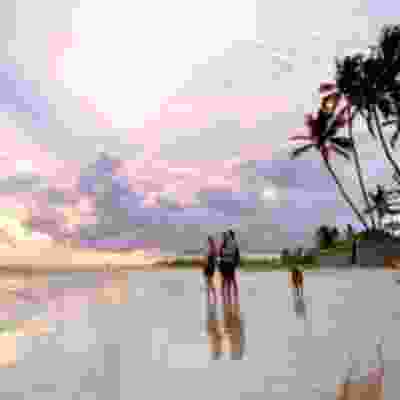 Travellers enjoying the sunset in beach town Negombo.