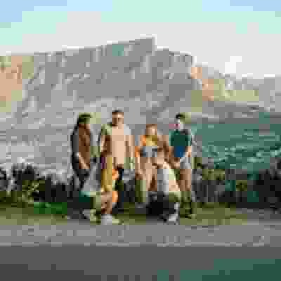 Group of travellers standing near viewpoint in Cape Town