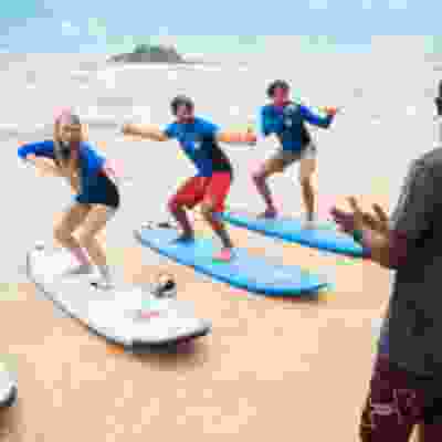 Four travellers learning to surf on Mirissa beach.