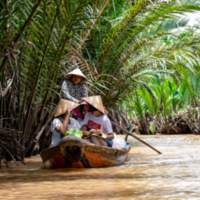 Mekong River Delta travellers on traditional boat