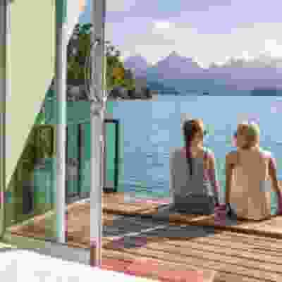 Two travellers enjoying the view from a floating bungalow.