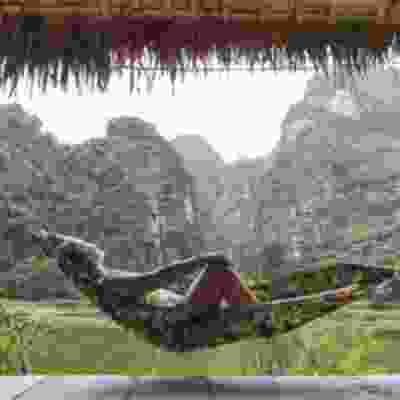 Women sitting in a hammock enjoying the view from a homestay in Ninh Binh.
