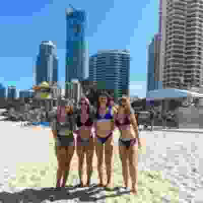 Girl group taking photo on the beach at Surfers Paradise.