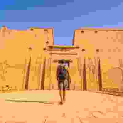 Male traveller walking towards the temple of the Horus.