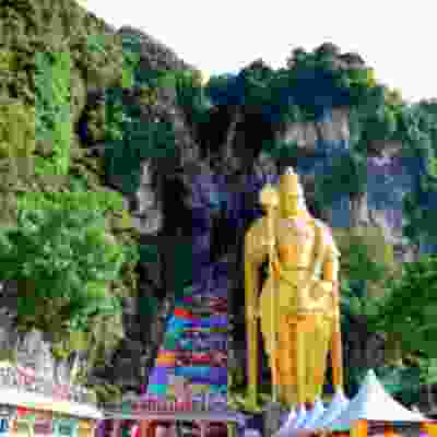 The view of gold statue outside of the Batu caves.