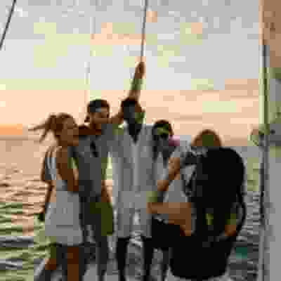 Travellers taking a group photo at end of boat out at sea in Caye Caulker.