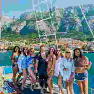 Group of women smiling on a boat trip in front of Brac island.