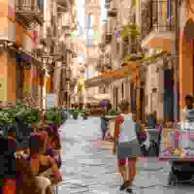 A traditional back street of cafes and shops in Palermo.