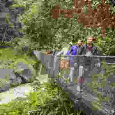 Travellers walking on the suspension bridge over Pacuare river.