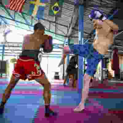 Two men taking part in Muay Thai boxing.
