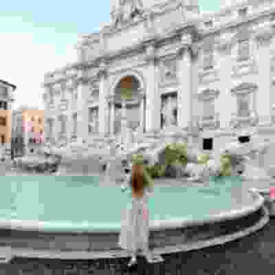 Women walking towards the Trevi fountain in Rome.